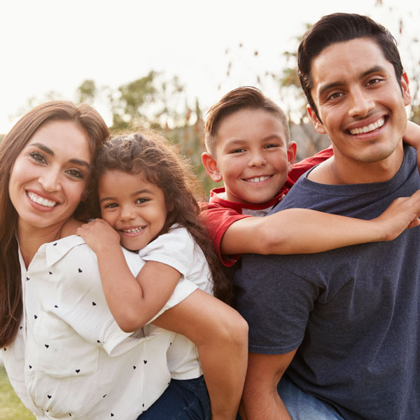 family of four smiling together